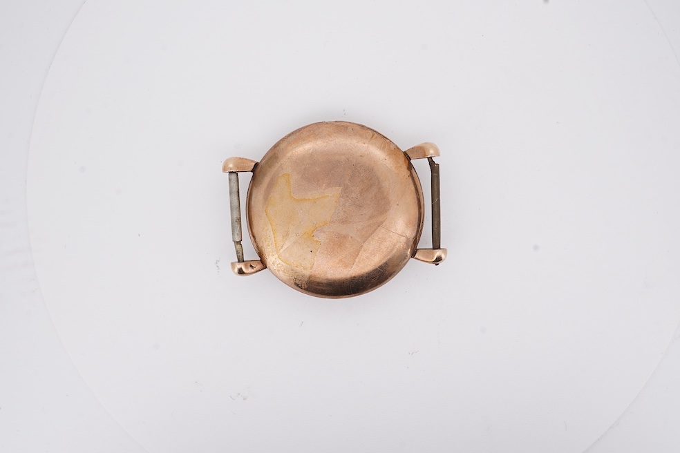 A gentleman's 1940's? 9ct gold Rolex manual wind wrist watch, with signed Super Balance movement, the inner case back numbered 4411 over 844, case diameter 34mm, no strap or winding crown. Condition - poor